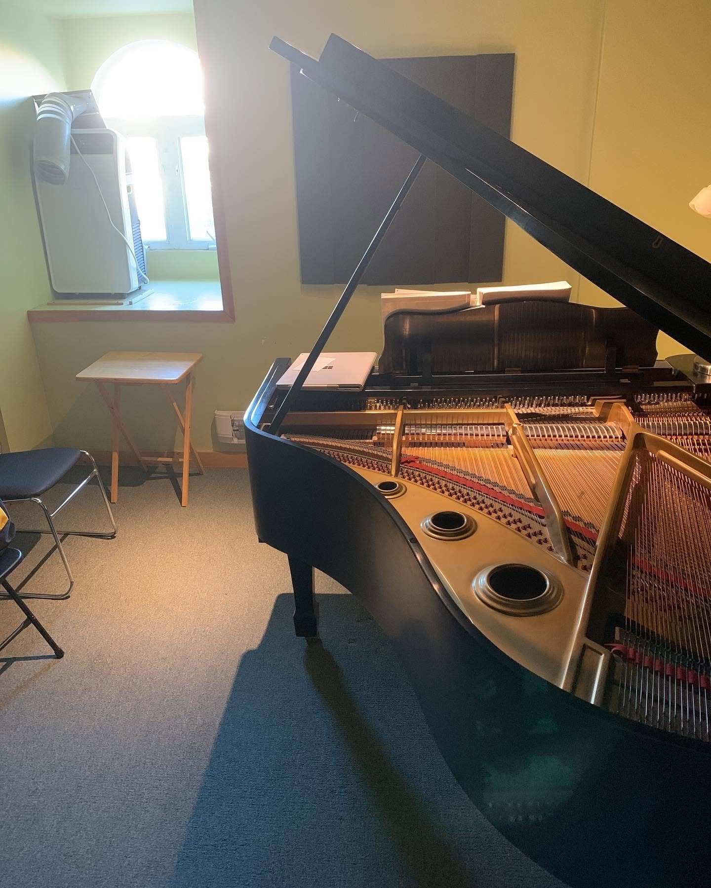 A concert grand piano in the studio