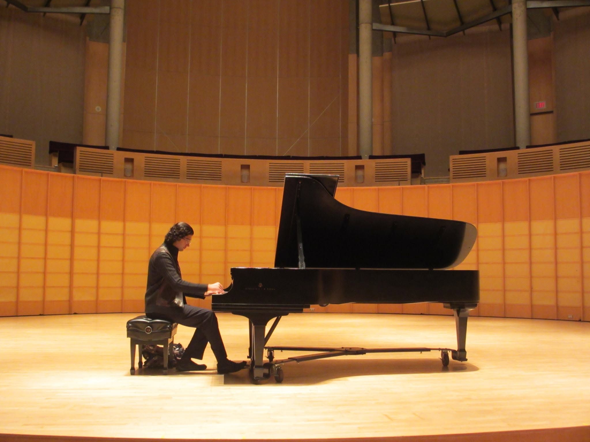 Saman Arfaie performing at a concert grand piano